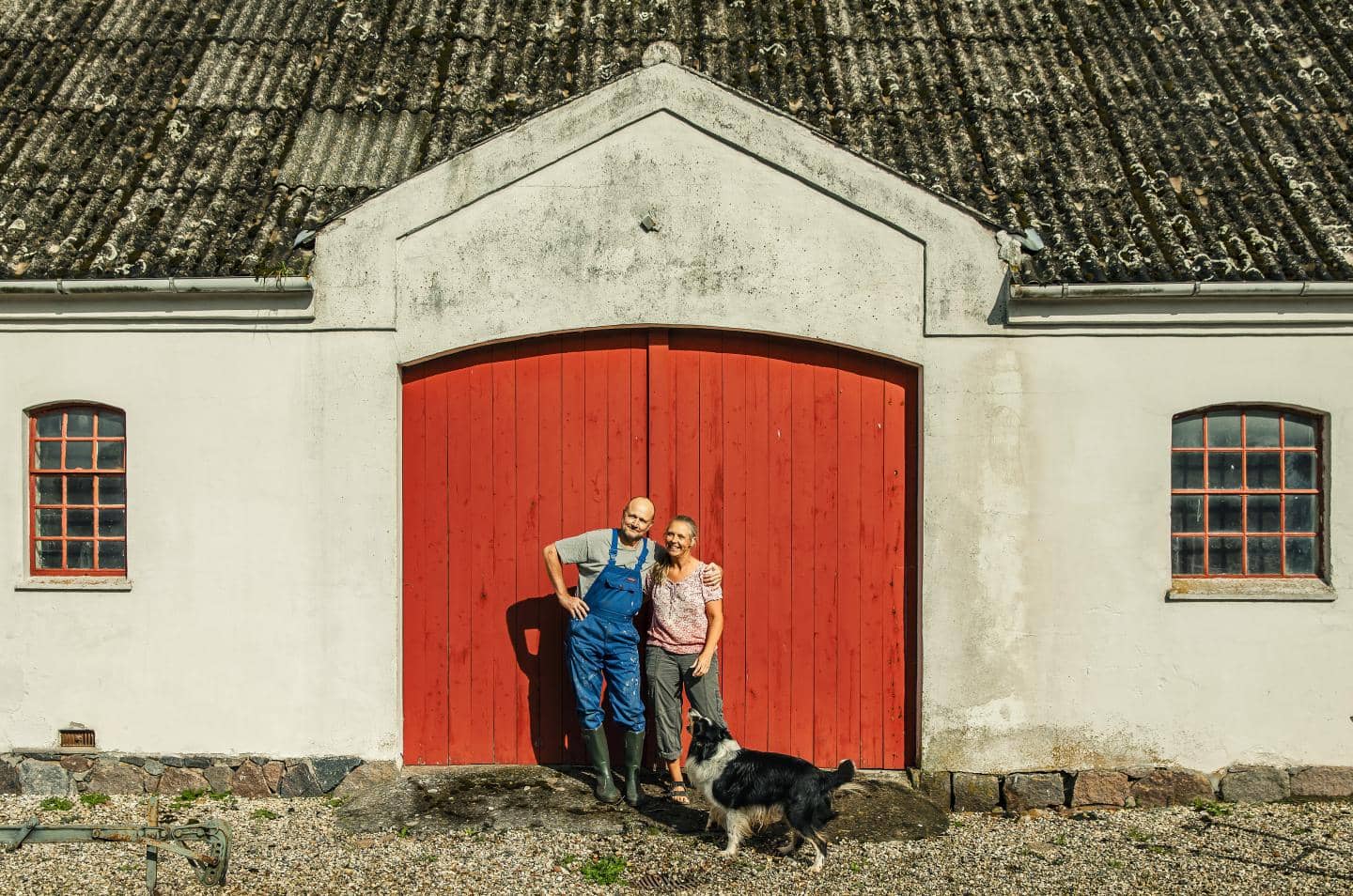 En kvinde og en mand foran en gård